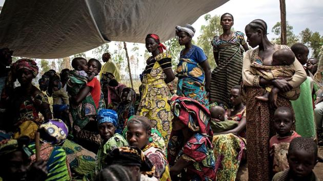Displaced Congolese women and children wait outside a health clinic set up by MSF in Telega. New conflicts are erupting and old ones are reviving as President Joseph Kabila seeks to maintain his grip on power two years after the legal end of his second term. Presidential elections, twice postponed, are now scheduled to take place on December 23. (John Wessels / AFP) Displaced Congolese women and children wait outside a health clinic set up by MSF in Telega. New conflicts are erupting and old ones are reviving as President Joseph Kabila seeks to maintain his grip on power two years after the legal end of his second term. Presidential elections, twice postponed, are now scheduled to take place on December 23. (John Wessels / AFP)