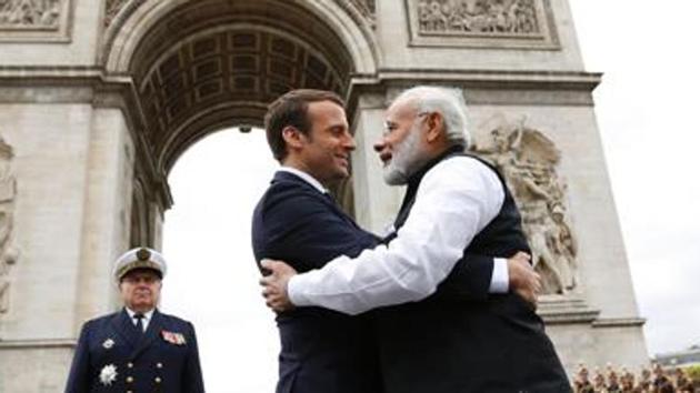 Prime Minister Narendra Modi (L) says goodbye to French President Emmanuel Macron after a ceremony at the Arc de Triomphe on the last leg of his four-nation visit in Paris, on June 3, 2017.(AFP File Photo)