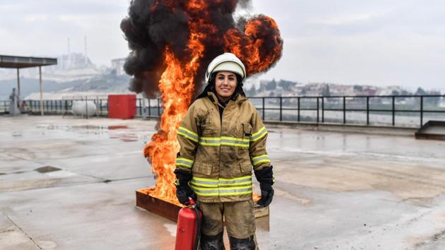 A female firefighter Devrim Ozdemir poses for  photographs during a training session in Izmir. “In the beginning, my family told me: ‘Stop, you won’t succeed, this is a job for men’,” said Ozdemir, who did not heed the advice. In 2008, she became one of the first women to put on a firefighter’s uniform in Turkey. (Bulent Kilic / AFP) 