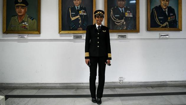 Anny Divya, 31, an Indian pilot who became the youngest woman in the world to captain the Boeing 777 aircraft, poses next to portraits of various air marshals at the Indian Air Force Museum in New Delhi. (Chandan Khanan / AFP) 
