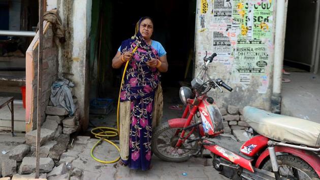 Rajpati Devi, 45, a bike mechanic and puncture repairer, poses at her roadside workshop in Allahabad. (Sanjoy Kanojia / AFP) 