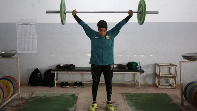 Huda Salem, a 20-year-old member of the Iraqi national weightlifting team, lifts weights as she trains at a gym in Baghdad. (Ahmad Al- Rubaye / AFP) 