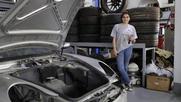 Lebanese mechanic Rana el-Hayek, 22, poses in a car repair garage where she works in Qannabat Brummana, northeast of Beirut. (Joesph Eid / AFP) 