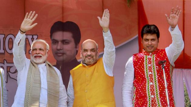 Prime Minister Narendra Modi with Bharatiya Janata Party (BJP) national president Amit Shah and the new Tripura chief mnister Biplab Kumar Deb during the swearing-in ceremony of the newly elected ministers, in Agartala on Friday. (PTI) Prime Minister Narendra Modi with Bharatiya Janata Party (BJP) national president Amit Shah and the new Tripura chief mnister Biplab Kumar Deb during the swearing-in ceremony of the newly elected ministers, in Agartala on Friday. (PTI)