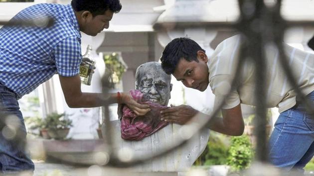 People clean the bust of Bharatiya Jana Sangh Bharat Keshri's founder Dr. Syama Prasad Mukherjee after it was vandalized by unknown people at Keoratola Mohasoshan in Kolkata on March 7, 2018. (PTI) People clean the bust of Bharatiya Jana Sangh Bharat Keshri's founder Dr. Syama Prasad Mukherjee after it was vandalized by unknown people at Keoratola Mohasoshan in Kolkata on March 7, 2018. (PTI)