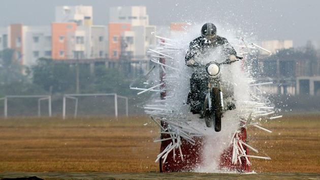 An Indian army member of the ‘Tornadoes’ motorcycle team rides through tube lights during a combined display at an officer training academy in Chennai on March 9, 2018. (Arun Sankar / AFP) An Indian army member of the ‘Tornadoes’ motorcycle team rides through tube lights during a combined display at an officer training academy in Chennai on March 9, 2018. (Arun Sankar / AFP)