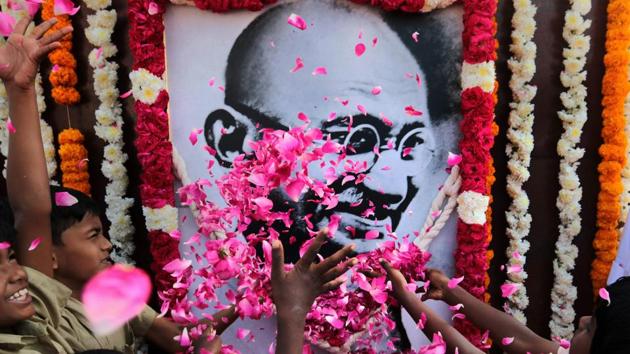 People pay homage to a portrait of Mahatma Gandhi on his death anniversary on January 30, in Chennai. (PTI File Photo) People pay homage to a portrait of Mahatma Gandhi on his death anniversary on January 30, in Chennai. (PTI File Photo)