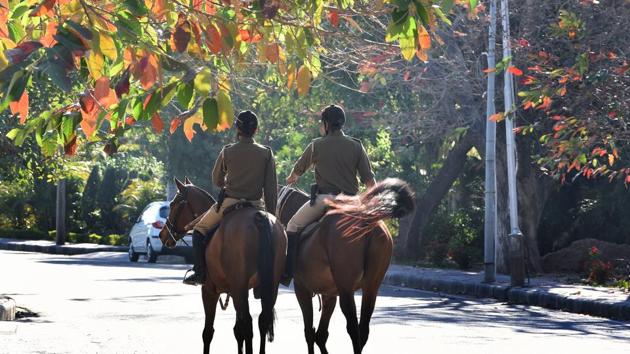 Policemen riding on internal road of sector -5 in Chandigarh. Another interesting aspect of spring is the shedding of leaves of trees like pilkhan and kusum. (Sanjeev Sharma/HT)
