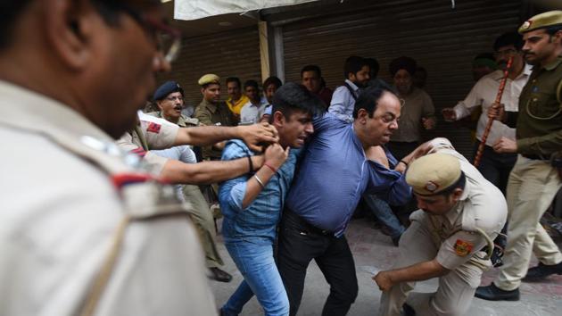 Shop owners protest after MCD officers sealed their shops following orders from the Monitoring Committee in Amar Colony Market, New Delhi on March 8, 2018. (Sanchit Khanna / HT Photo) Shop owners protest after MCD officers sealed their shops following orders from the Monitoring Committee in Amar Colony Market, New Delhi on March 8, 2018. (Sanchit Khanna / HT Photo)