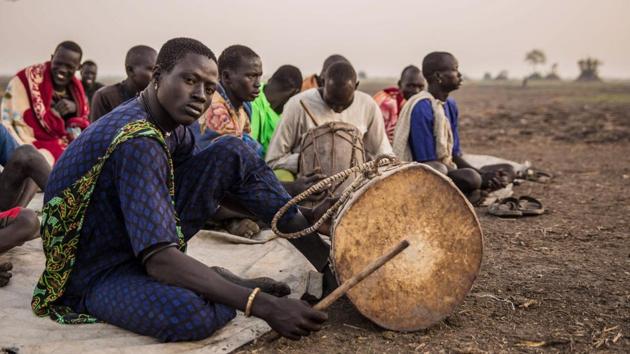 Dinka people gather for church prayers in the early morning at the cattle camp. Unlike the Arabised Islamic population in the north, the population in the south of Sudan, of which the Dinka are a majority, maintained animist religious beliefs which were mixed into Christianity in the 19th century. These differences were exacerbated in the Sudanese civil wars that began in 1955. (Stefanie Glinski / AFP) 