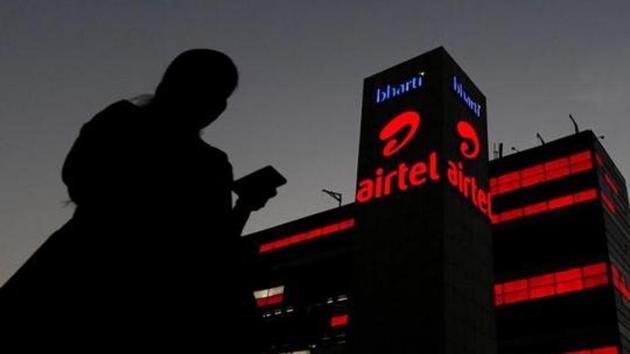 A girl checks her mobile phone as she walks past the Bharti Airtel office building in Gurugram on the outskirts of New Delhi. (Reuters File) A girl checks her mobile phone as she walks past the Bharti Airtel office building in Gurugram on the outskirts of New Delhi. (Reuters File)