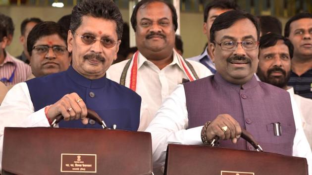 State finance minister Sudhir Mungantiwar (right) and his junior minister Deepak Vasant Kesarkar pose before presenting the fourth budget of the BJP government, outside Vidhan Bhavan in Mumbai on Friday. (Anshuman Poyrekar/HT Photo) State finance minister Sudhir Mungantiwar (right) and his junior minister Deepak Vasant Kesarkar pose before presenting the fourth budget of the BJP government, outside Vidhan Bhavan in Mumbai on Friday. (Anshuman Poyrekar/HT Photo)