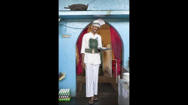 Sangaran, a waiter who has worked at the coffee shop for 17 years. The Indian Coffee House, Kollam (now closed), 2013. (© Stuart Freedman / Tasveer)