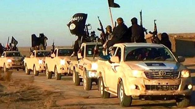 In this undated photo released by a militant website, militants of the Islamic State group hold up their weapons and wave its flags on their vehicles in a convoy on a road leading to Iraq, while riding in Raqqa city in Syria. (AP File Photo) In this undated photo released by a militant website, militants of the Islamic State group hold up their weapons and wave its flags on their vehicles in a convoy on a road leading to Iraq, while riding in Raqqa city in Syria. (AP File Photo)