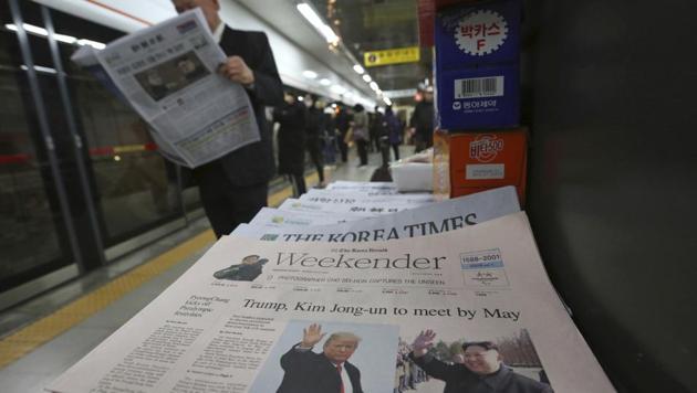 A newspaper with headline of a planned summit meeting between North Korean leader Kim Jong Un and US President Donald Trump, left, is displayed at a subway station in Seoul, South Korea.(AP)
