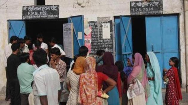 People queue outside a ration shop in Bawana.(HT File)