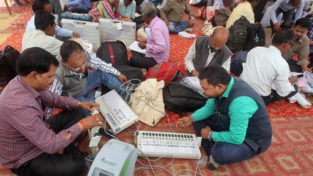 Officials check electronic voting machines (EVM) after collecting them from a distribution center on the eve of Phulpur bypoll elections in Allahabad on Saturday. (PTI Photo) Officials check electronic voting machines (EVM) after collecting them from a distribution center on the eve of Phulpur bypoll elections in Allahabad on Saturday. (PTI Photo)