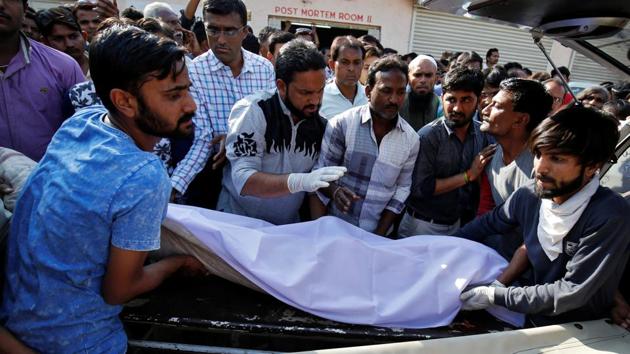 People move the body of a victim, who died in a truck accident, into a vehicle after the post-mortem examination at a government hospital in a village in Bhavnagar district on March 6, 2018. (Reuters Photo) People move the body of a victim, who died in a truck accident, into a vehicle after the post-mortem examination at a government hospital in a village in Bhavnagar district on March 6, 2018. (Reuters Photo)