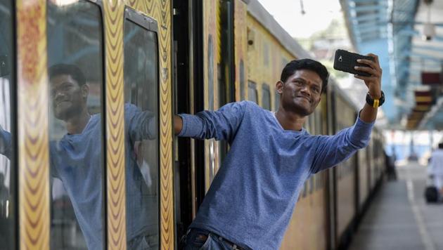 A man leans out of the Tejas train to snap a selfie at the CST in Mumbai, in May 2017. (Kunal Patil/HT Photo) A man leans out of the Tejas train to snap a selfie at the CST in Mumbai, in May 2017. (Kunal Patil/HT Photo)