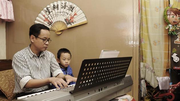Mechanical engineer Thomas Chen with his son, Travis, at his home in Bow Bazaar, central Kolkata. ‘I am almost Bangali,’ he says. Chen has done a cameo in a Salman Khan film and also sings in Bengali, Hindi and Mandarin. (Samir Jana / HT PHOTO)