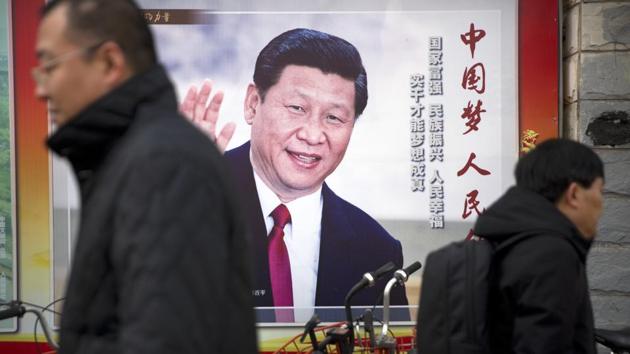 Residents walk past a poster showing Chinese President Xi Jinping in Beijing. (AP Photo) Residents walk past a poster showing Chinese President Xi Jinping in Beijing. (AP Photo)