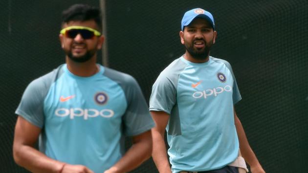 Indian cricket captain Rohit Sharma (R) and Suresh Raina look on at a training session at the R. Premadasa Stadium in Colombo on March 11, 2018.  (AFP) 