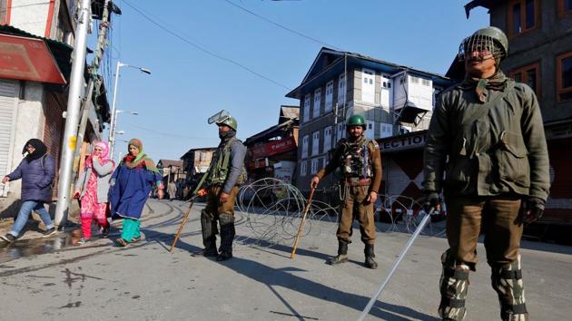 Policemen stand guard on a road after in Srinagar. (REUTERS) Policemen stand guard on a road after in Srinagar. (REUTERS)