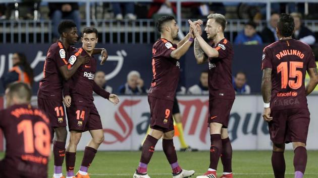 Barcelona's Luis Suarez, center, celebrates scoring the opening goal during a Spanish La Liga match against Malaga on Saturday. (AP) Barcelona's Luis Suarez, center, celebrates scoring the opening goal during a Spanish La Liga match against Malaga on Saturday. (AP)