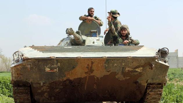 Syrian regime forces sit inside a tank in the town of Aftris, west of the rebel-held town of Saqba, in the besieged Eastern Ghouta region on the outskirts of the capital Damascus. (AFP Photo) Syrian regime forces sit inside a tank in the town of Aftris, west of the rebel-held town of Saqba, in the besieged Eastern Ghouta region on the outskirts of the capital Damascus. (AFP Photo)