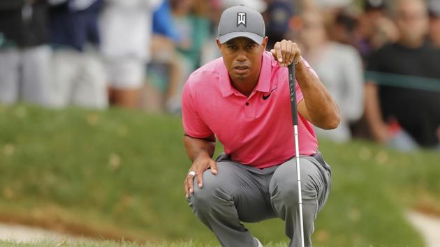 Tiger Woods lines up his putt on the third hole during the third round of the Valspar Championship golf tournament on Saturday.(AP)