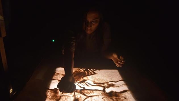 A student of COEP performs sand art during the 90th Regatta at Boat Club in Pune. (Pratham Gokhale/HT Photo)