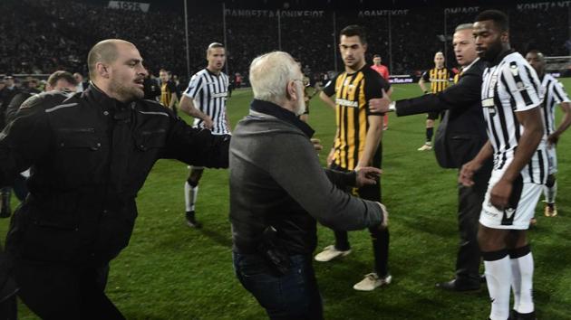 PAOK Thessaloniki owner Ivan Savvidis takes to the pitch carrying a handgun in his waistband during a Greek Super League football match. (AFP) PAOK Thessaloniki owner Ivan Savvidis takes to the pitch carrying a handgun in his waistband during a Greek Super League football match. (AFP)