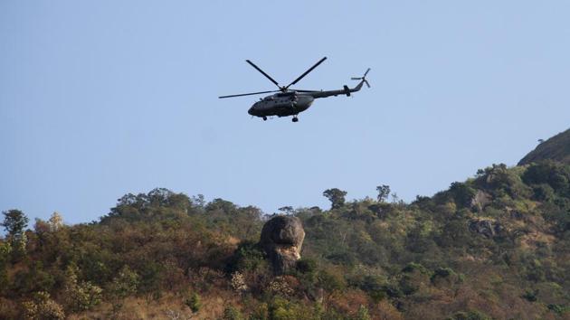 A Indian air force helicopter patrols during a rescue mission at Kurangani Hill in the district of Theni on Monday.(AFP)