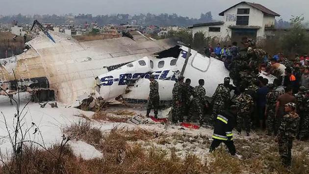 Nepalese rescue workers gather around the debris of an airplane that crashed near the international airport in Kathmandu. Civil Aviation Authority of Nepal director general Sanjiv Gautam said: “The aircraft was permitted to land from the southern side of the runway flying over Koteshwor but it landed from the northern side.” (AFP)