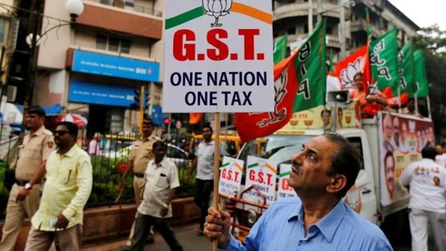 A supporter of the Bharatiya Janata Party holds a placard during a rally to support implementation of the Goods and Services Tax (GST) in Mumbai on June 30, 2017. (Reuters file photo) A supporter of the Bharatiya Janata Party holds a placard during a rally to support implementation of the Goods and Services Tax (GST) in Mumbai on June 30, 2017. (Reuters file photo)