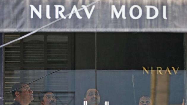Security guards stand inside a Nirav Modi showroom during a raid by the Enforcement Directorate, a government agency that fights financial crime, in New Delhi.(REUTERS File Photo)