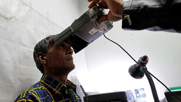 A man has his iris scanned for Aadhaar generation, at a centre in New Delhi. The Supreme Court extended on Tuesday the March 31 deadline to link Aadhaar with various services till a constitution bench hearing the matter delivers a judgment. A five-judge bench headed by Chief Justice Dipak Misra, however, said Aadhaar will continue to be mandatory for direct benefit transfers under welfare schemes. (Saumya Khandelwal / REUTERS File) A man has his iris scanned for Aadhaar generation, at a centre in New Delhi. The Supreme Court extended on Tuesday the March 31 deadline to link Aadhaar with various services till a constitution bench hearing the matter delivers a judgment. A five-judge bench headed by Chief Justice Dipak Misra, however, said Aadhaar will continue to be mandatory for direct benefit transfers under welfare schemes. (Saumya Khandelwal / REUTERS File)