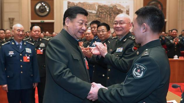 In this photo released by Xinhua News Agency, Chinese President Xi Jinping (centre) shakes hands with delegation of People’s Liberation Army and armed police during a meeting in Beijing, Monday. (AP Photo) In this photo released by Xinhua News Agency, Chinese President Xi Jinping (centre) shakes hands with delegation of People’s Liberation Army and armed police during a meeting in Beijing, Monday. (AP Photo)