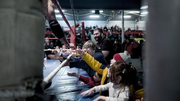 Wrestler Zack claps hands with children during a wrestling match. Entry was free for kids and just 8 euros ($10) for the rest, and the 1,200-capacity hall was full. Funds went to the non-profit association. (Kamil Zihnioglu / AP) Wrestler Zack claps hands with children during a wrestling match. Entry was free for kids and just 8 euros ($10) for the rest, and the 1,200-capacity hall was full. Funds went to the non-profit association. (Kamil Zihnioglu / AP)