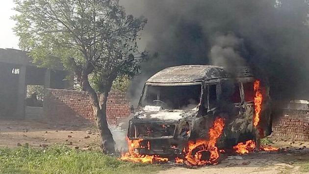 Angry villagers set a vehicle on fire at Manochahal village on Tuesday. (Sameer Sehgal/HT)