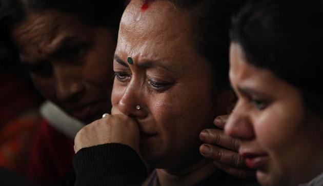 Family members of US-Bangla Airlines plane crash victims outside a morgue at the Teaching Hospital in Kathmandu on Tuesday, a day after 49 people were killed and 22 injured when the Bangladeshi plane crashed and burst into flames near Nepal’s Tribhuvan International airport.(AP)