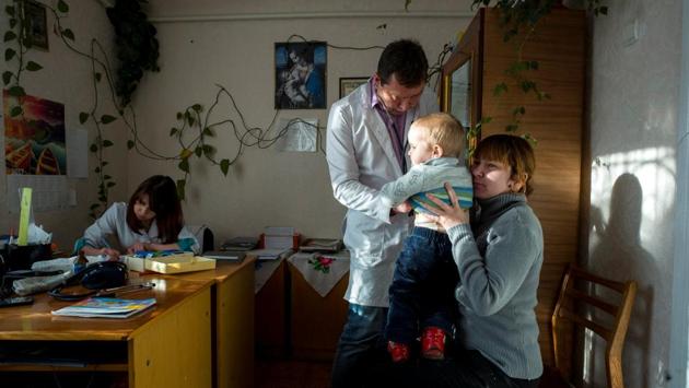 His clinic’s decrepit central heating system occasionally fails in the middle of winter, prompting parents to keep their children bundled up in snow-suits during consultations. (Gleb Garanich / REUTERS) His clinic’s decrepit central heating system occasionally fails in the middle of winter, prompting parents to keep their children bundled up in snow-suits during consultations. (Gleb Garanich / REUTERS)