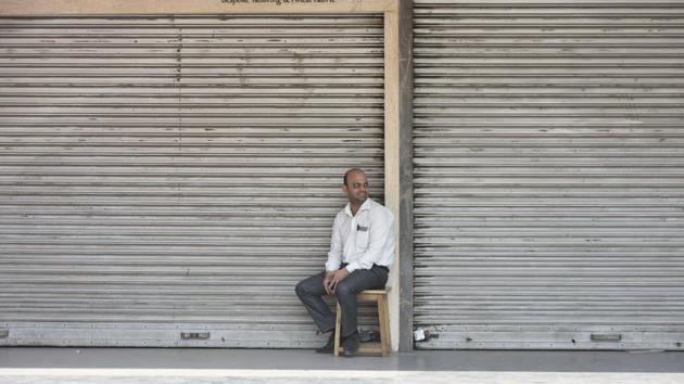 A shopkeeper sits in front of a shop at South Extension Part I as traders on Tuesday decided to observe a ‘trade bandh’ against the ongoing sealing drive by the municipal corporations.(Vipin Kumar / HT Photo)