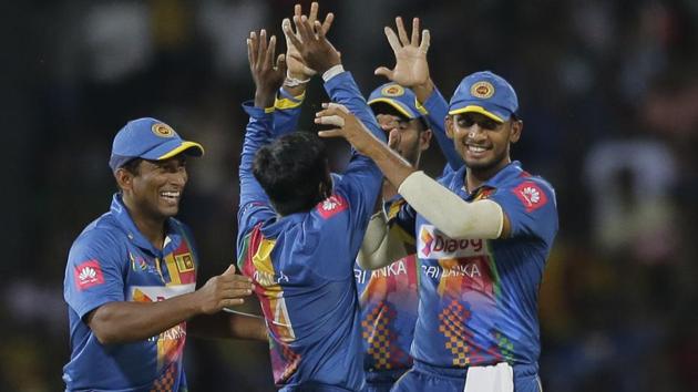 Sri Lankan team members congratulate Akila Dananjaya, center, for the dismissal of India's Shikhar Dhawan. (AP) Sri Lankan team members congratulate Akila Dananjaya, center, for the dismissal of India's Shikhar Dhawan. (AP)