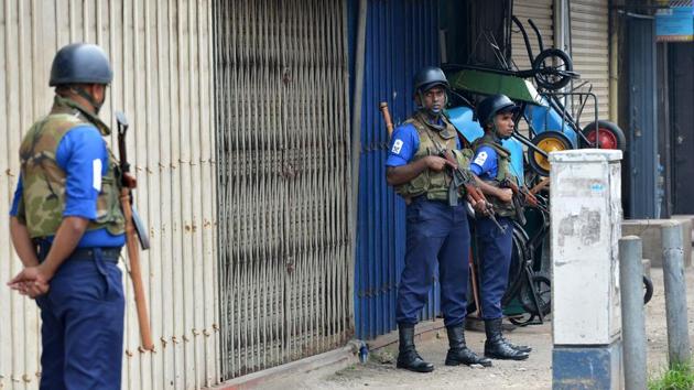 Sri Lankan Navy soldiers stand guard next to shops that have been closed in protest following deadly communal violence in other parts of the country, in Sri Lanka’s capital Colombo on March 9. (AFP Photo) Sri Lankan Navy soldiers stand guard next to shops that have been closed in protest following deadly communal violence in other parts of the country, in Sri Lanka’s capital Colombo on March 9. (AFP Photo)