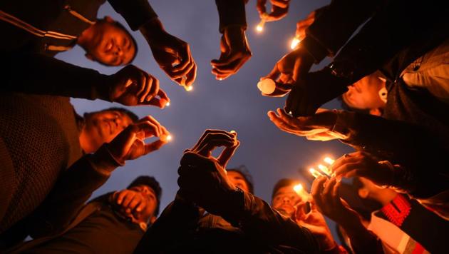 Nepali people take part in a candle light vigil in honour of the plane crash victims in Kathmandu on March 13, 2018, a day after the deadly crash of a US-Bangla Airlines plane at the international airport.(AFP Photo)