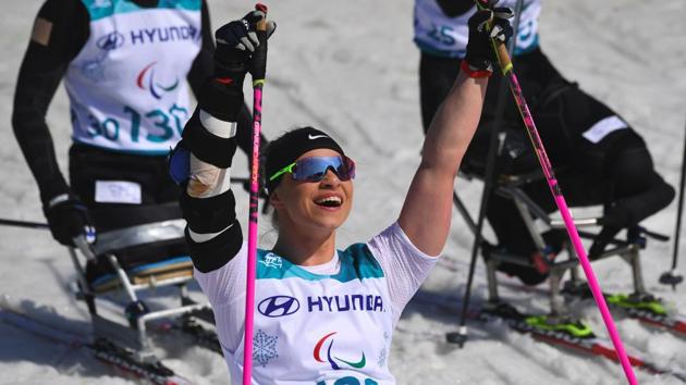 Oksana Masters of the US celebrates her victory after crossing the finish line in the women's 1.1km sprint sitting cross-country skiing final event of the Pyeongchang Winter Paralympics at the Alpensia Biathlon Centre.(AFP)