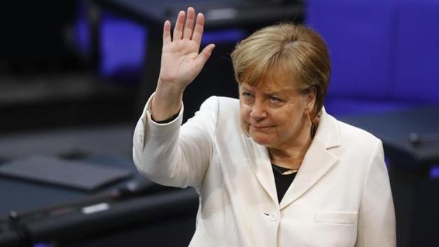 Chancellor Angela Merkel waves during a session of the German lower house of parliament Bundestag to elect a new chancellor, in Berlin, Germany.(REUTERS)