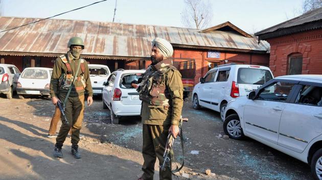 Police personnel stand near vehicles damaged in a blast caused by a grenade allegedly hurled by militants in Pulwama. (PTI File Photo) Police personnel stand near vehicles damaged in a blast caused by a grenade allegedly hurled by militants in Pulwama. (PTI File Photo)
