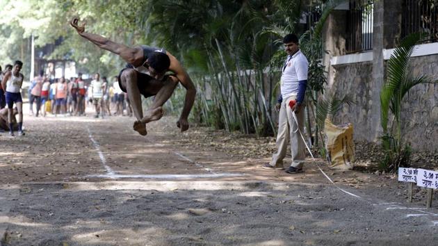 A police aspirant performs long jump at the police recruitment drive at Shivajinagar Police Headquaters in Pune. (rahul raut/ht photo )